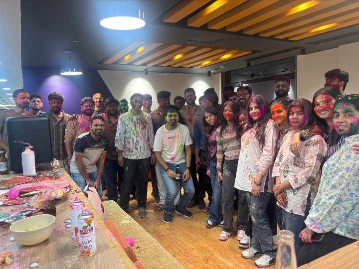 Holi celebration, team covered in colors